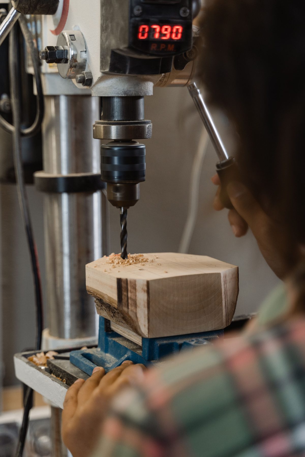 Timber block clamped and drilled on a drill press